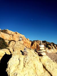 Rock formations against clear blue sky