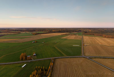 The country roads cross the autumn fields at the northern finland. 
