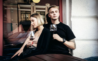 Full length of a young couple drinking glass