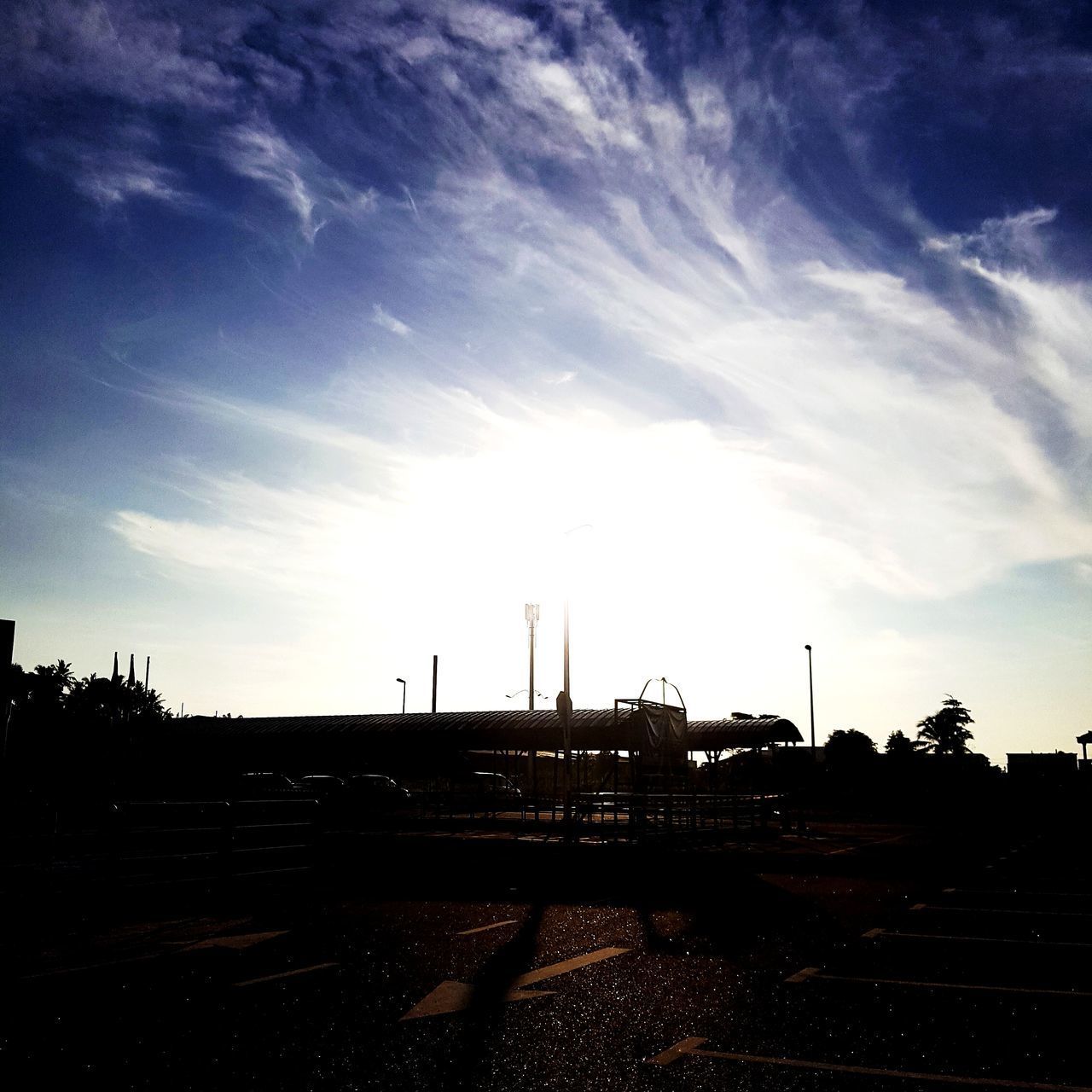 SILHOUETTE OF FACTORY AGAINST SKY