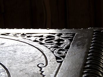 Close-up of metallic object on wooden surface