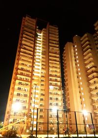 Low angle view of illuminated skyscrapers at night