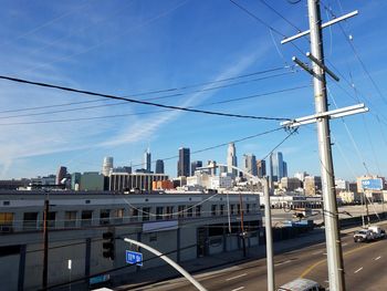 View of cityscape against cloudy sky