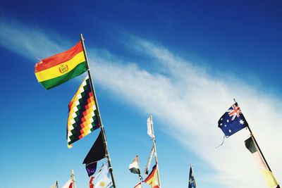 Various flags at salar de uyuni against sky