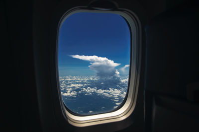 View of cloudy sky seen through airplane window