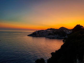 Scenic view of sea against sky at sunset