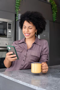 Portrait of young woman using mobile phone