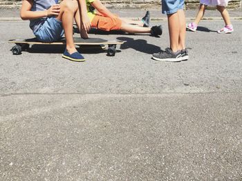 Low section of kids with skateboard in park