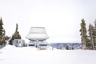Built structure on snow covered landscape against clear sky