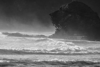 Man surfing in sea against sky