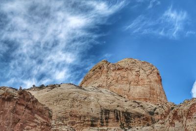 Low angle view of rock formations against sky