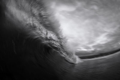 Moving wave breaking on canary islands beach in black and white