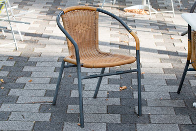 High angle view of empty chairs on sidewalk