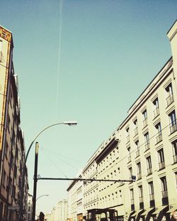 Low angle view of buildings against clear blue sky