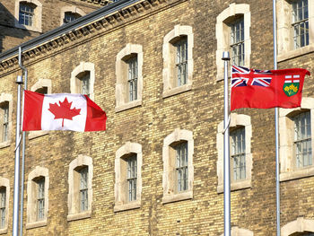 Low angle view of flag against building