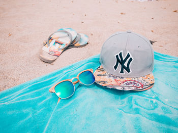 High angle view of sunglasses on sand