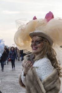 Smiling woman in costume and mask during event