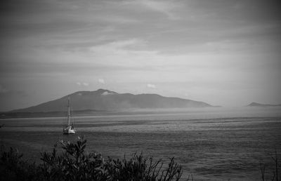 Scenic view of calm sea against cloudy sky