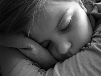 Close-up of baby sleeping on bed