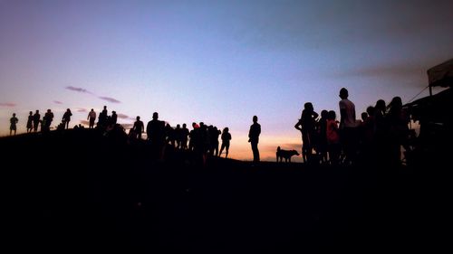 Silhouette of men against sky