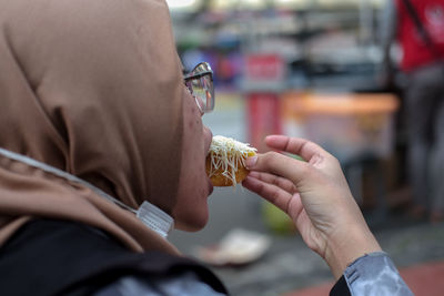 Midsection of woman holding ice cream