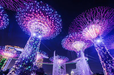 Low angle view of firework display at night