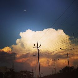 Low angle view of electricity pylon against sky