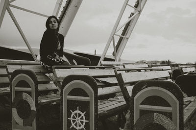 Low angle view of woman standing by railing