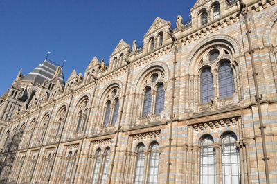 Low angle view of historic building against clear blue sky