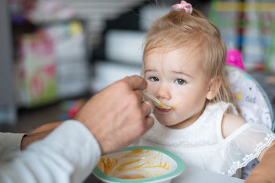 Portrait of cute girl eating food