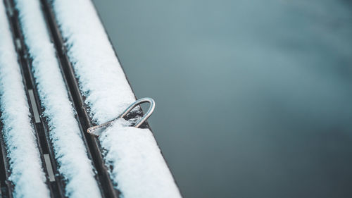 Close-up of snow on metal railing