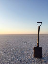 Close-up of sea against clear sky during sunset