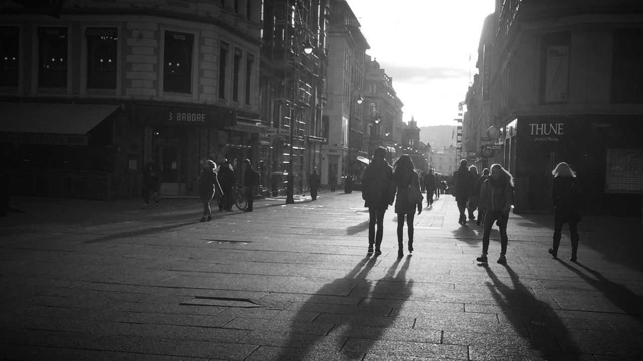 building exterior, architecture, built structure, street, walking, city, men, the way forward, city life, person, lifestyles, road, city street, large group of people, full length, building, sky, rear view, transportation