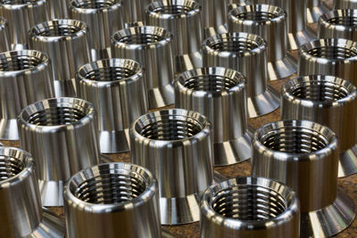 Close-up of wine glasses on metal in factory