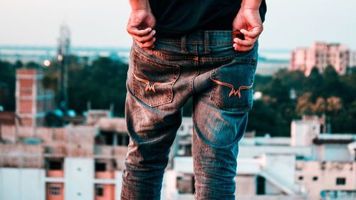 Low section of man standing on city street