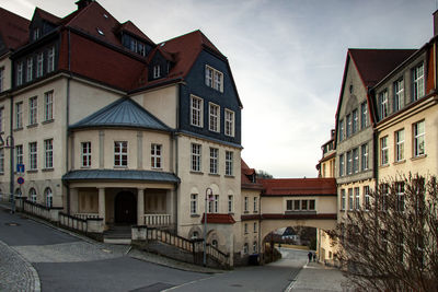 Street amidst buildings in city against sky