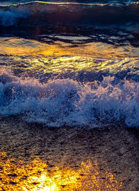 Close-up of yellow water on sea shore