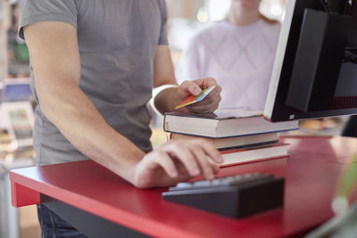 Student borrowing books with library card