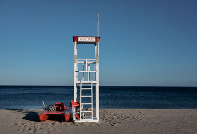 Lifeguard hut on beach against clear sky