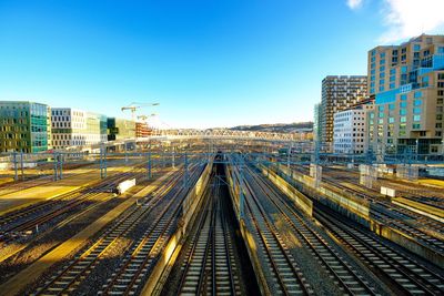 Railroad tracks in city against clear sky