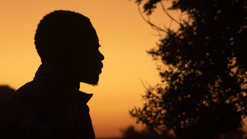 Low angle view of a man against sky during sunrise