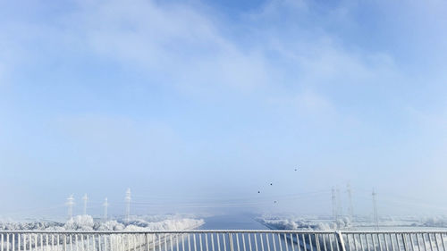 Railing against canal and sky during winter