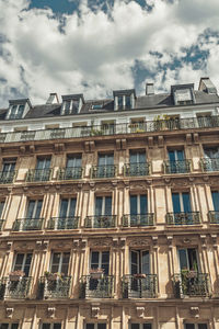 Low angle view of building against cloudy sky