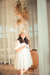 Portrait of woman standing at home