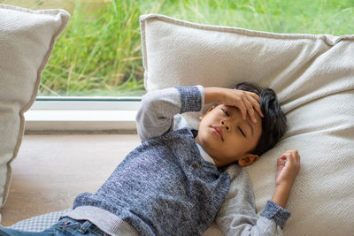 High angle view of boy sleeping on bed