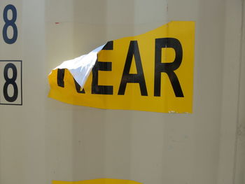 Close-up of yellow text on wall