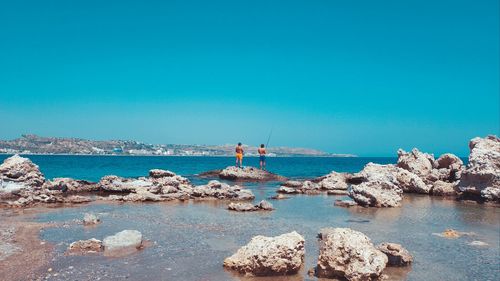 Scenic view of sea against clear blue sky