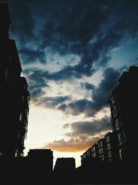 Low angle view of silhouette city against sky during sunset