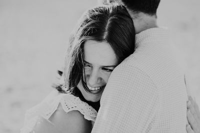 Couple embracing while standing on beach