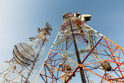 Low angle view of communications tower against sky